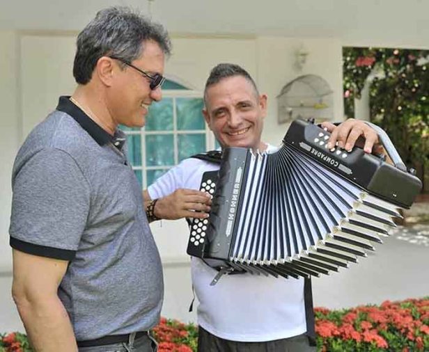 El Rey Vallenato Julián Rojas, tocando el regalo que le llevó el Presidente de la Fundación Festival de la Leyenda Vallenata, Rodolfo Molina Araújo